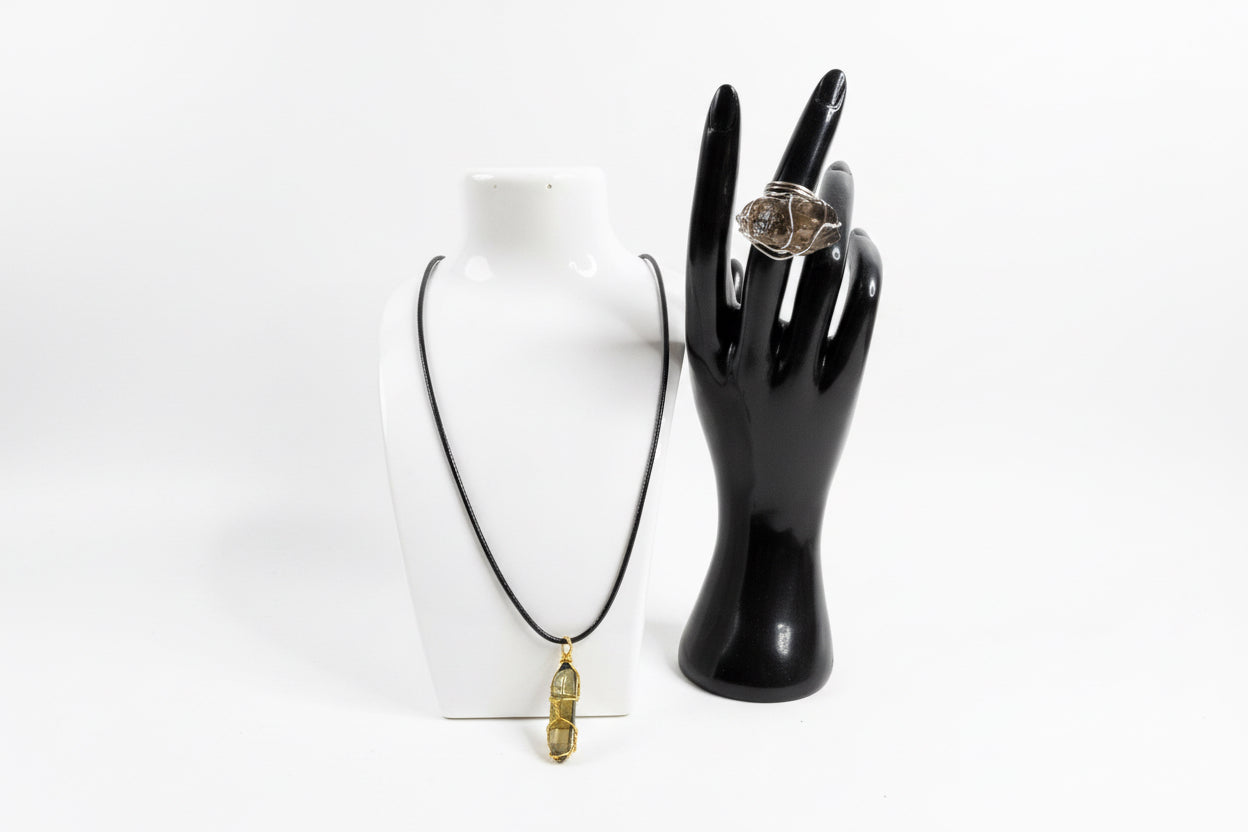 Black on waxed necklace and black hand-shaped jewelry holder with a smoky quartz ring
